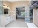 Bathroom with dual sink vanity, shower, linen closet and open view into main bedroom at 5776 White Acres Ln, Port Orange, FL 32127