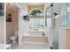 Well-lit bathroom with a garden tub and a separate glass shower at 5776 White Acres Ln, Port Orange, FL 32127