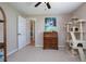 Neutral bedroom with a ceiling fan, art and a pet playhouse at 5776 White Acres Ln, Port Orange, FL 32127