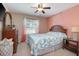 Cozy bedroom features a ceiling fan, window, and comfortable furniture at 5776 White Acres Ln, Port Orange, FL 32127