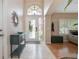 Bright foyer with tiled floor, glass front door, and elegant console table at 5776 White Acres Ln, Port Orange, FL 32127