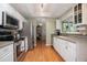 Modern kitchen with stainless steel appliances, white cabinets, and hardwood floors at 5776 White Acres Ln, Port Orange, FL 32127