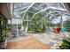 Enjoy the outdoors in this screened-in porch with stone flooring and outdoor seating areas at 5776 White Acres Ln, Port Orange, FL 32127