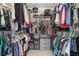 Organized walk-in closet with shelving and hanging space for clothes and accessories at 5776 White Acres Ln, Port Orange, FL 32127
