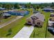 Aerial view of cozy home with neat landscaping, concrete driveway, and proximity to other properties at 707 Hamilton St, New Smyrna Beach, FL 32168