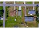 Aerial view of the property showing a well-maintained lawn, long driveway and proximity to neighboring homes at 707 Hamilton St, New Smyrna Beach, FL 32168