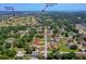 Aerial view of a neighborhood with mature trees, nearby golf course, and New Smyrna Beach Airport at 707 Hamilton St, New Smyrna Beach, FL 32168