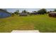 Large backyard with green grass, detached shed, and space for entertaining at 707 Hamilton St, New Smyrna Beach, FL 32168