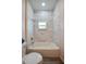 Bathroom featuring decorative wall tiles, a shower-tub combo, and modern fixtures at 707 Hamilton St, New Smyrna Beach, FL 32168