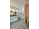 Bathroom with dual sinks, stone countertop, and decorative pebble shower stall at 707 Hamilton St, New Smyrna Beach, FL 32168