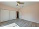 Bedroom featuring wood-look flooring, two closets, a ceiling fan, and neutral walls at 707 Hamilton St, New Smyrna Beach, FL 32168