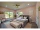 Staged bedroom with two large windows, ceiling fan, and a king bed at 707 Hamilton St, New Smyrna Beach, FL 32168