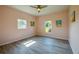 Empty bedroom with two windows, ceiling fan, and wood-look floors at 707 Hamilton St, New Smyrna Beach, FL 32168