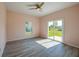 Bright bedroom with sliding glass door access to the backyard and light wood-look flooring at 707 Hamilton St, New Smyrna Beach, FL 32168