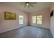 Bright bedroom with ceiling fan, two windows, and light pink walls at 707 Hamilton St, New Smyrna Beach, FL 32168