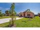 Inviting single-Gathering home featuring a well-maintained lawn and concrete driveway at 707 Hamilton St, New Smyrna Beach, FL 32168