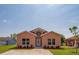 Charming single-story home with well-manicured lawn and concrete driveway at 707 Hamilton St, New Smyrna Beach, FL 32168
