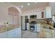 Kitchen featuring stainless steel appliances, granite countertops and light woodgrain flooring at 707 Hamilton St, New Smyrna Beach, FL 32168