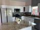 Modern kitchen featuring white cabinets, granite countertops, and stainless steel appliances at 707 Hamilton St, New Smyrna Beach, FL 32168
