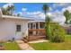 Well-maintained backyard featuring a wood deck, screened porch, and lush green grass at 738 Lindley Blvd, Deland, FL 32724