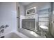Clean and bright bathroom featuring a gray vanity, tiled walls, and a shower/tub combo at 738 Lindley Blvd, Deland, FL 32724