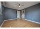 Dark gray bedroom features hardwood floors, closet, and doorway leading to another room at 738 Lindley Blvd, Deland, FL 32724