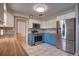 Bright kitchen featuring updated stainless steel appliances, butcher block countertops, and stylish blue cabinets at 738 Lindley Blvd, Deland, FL 32724