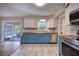 Well-lit kitchen with modern stainless steel appliances, stylish tile flooring, and a view to the patio at 738 Lindley Blvd, Deland, FL 32724