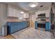 Bright kitchen featuring white and blue cabinets, butcher block countertops, and stainless steel appliances at 738 Lindley Blvd, Deland, FL 32724