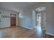 Inviting living room features gleaming hardwood floors and neutral walls, leading to a bathroom at 738 Lindley Blvd, Deland, FL 32724