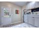 Bright mud room features door to the backyard, laundry area, and tile flooring at 738 Lindley Blvd, Deland, FL 32724