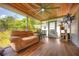 Cozy screened porch features a ceiling fan, outdoor seating, and pet amenities at 738 Lindley Blvd, Deland, FL 32724