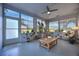 Relaxing sunroom with abundant natural light, large windows, neutral paint, and tile flooring at 738 Lindley Blvd, Deland, FL 32724