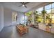 Inviting sunroom offers lots of natural light and a unique coffee table at 738 Lindley Blvd, Deland, FL 32724