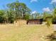 Large backyard featuring a shed and outdoor cooking area at 7380 Orange Ave, Indian Lake Estates, FL 33855