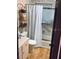 Functional bathroom with a shower-tub combo, toilet, vanity, and storage shelves at 7380 Orange Ave, Indian Lake Estates, FL 33855