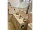 Bathroom featuring neutral wall tiles, a single sink, and ample counter space at 7380 Orange Ave, Indian Lake Estates, FL 33855