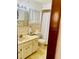 Bathroom features light-colored tile, a single sink vanity, and a toilet at 7380 Orange Ave, Indian Lake Estates, FL 33855