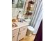 Functional bathroom featuring a vanity, toilet, and shower with storage shelves at 7380 Orange Ave, Indian Lake Estates, FL 33855