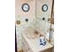 Compact bathroom with a sink, mirror, tilework, and vintage fixtures for a classic feel at 7380 Orange Ave, Indian Lake Estates, FL 33855