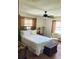 Bedroom featuring bamboo frame bed with white bedding and a woven trunk at 7380 Orange Ave, Indian Lake Estates, FL 33855