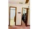 Bedroom with closet and bathroom access, and neutral carpet at 7380 Orange Ave, Indian Lake Estates, FL 33855