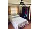 Cozy bedroom featuring a ceiling fan, closet, and comfortable bed with floral patterned linens at 7380 Orange Ave, Indian Lake Estates, FL 33855