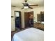 Bedroom features an ample closet, bamboo furniture, and ceiling fan at 7380 Orange Ave, Indian Lake Estates, FL 33855