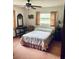 Comfortable bedroom with a ceiling fan, neutral tones, and ample natural light at 7380 Orange Ave, Indian Lake Estates, FL 33855