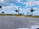 Scenic view of a community park area with palm trees and a lake view in Indian Lake Estates at 7380 Orange Ave, Indian Lake Estates, FL 33855