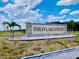 Prominent Indian Lake Estates entrance sign with palm trees and landscaping, welcoming residents and visitors at 7380 Orange Ave, Indian Lake Estates, FL 33855