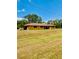Single-story home with a spacious front lawn, showcasing a tranquil residential setting at 7380 Orange Ave, Indian Lake Estates, FL 33855