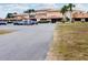 Spacious two-story commercial building with large parking and well-maintained landscaping at 7380 Orange Ave, Indian Lake Estates, FL 33855