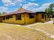 Charming home with a terracotta tiled roof and warm yellow exterior at 7380 Orange Ave, Indian Lake Estates, FL 33855